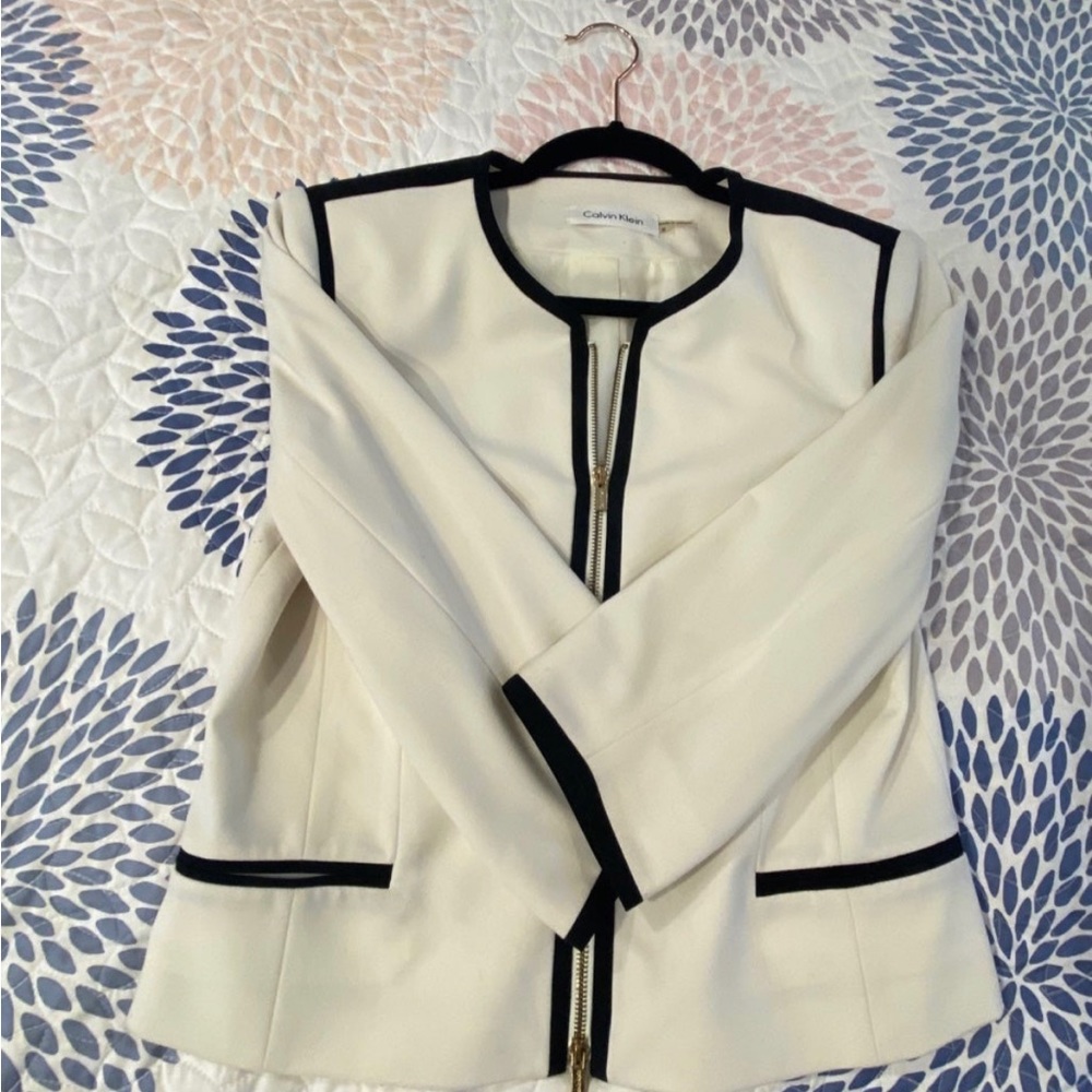 CK white blazer with black and gold accents